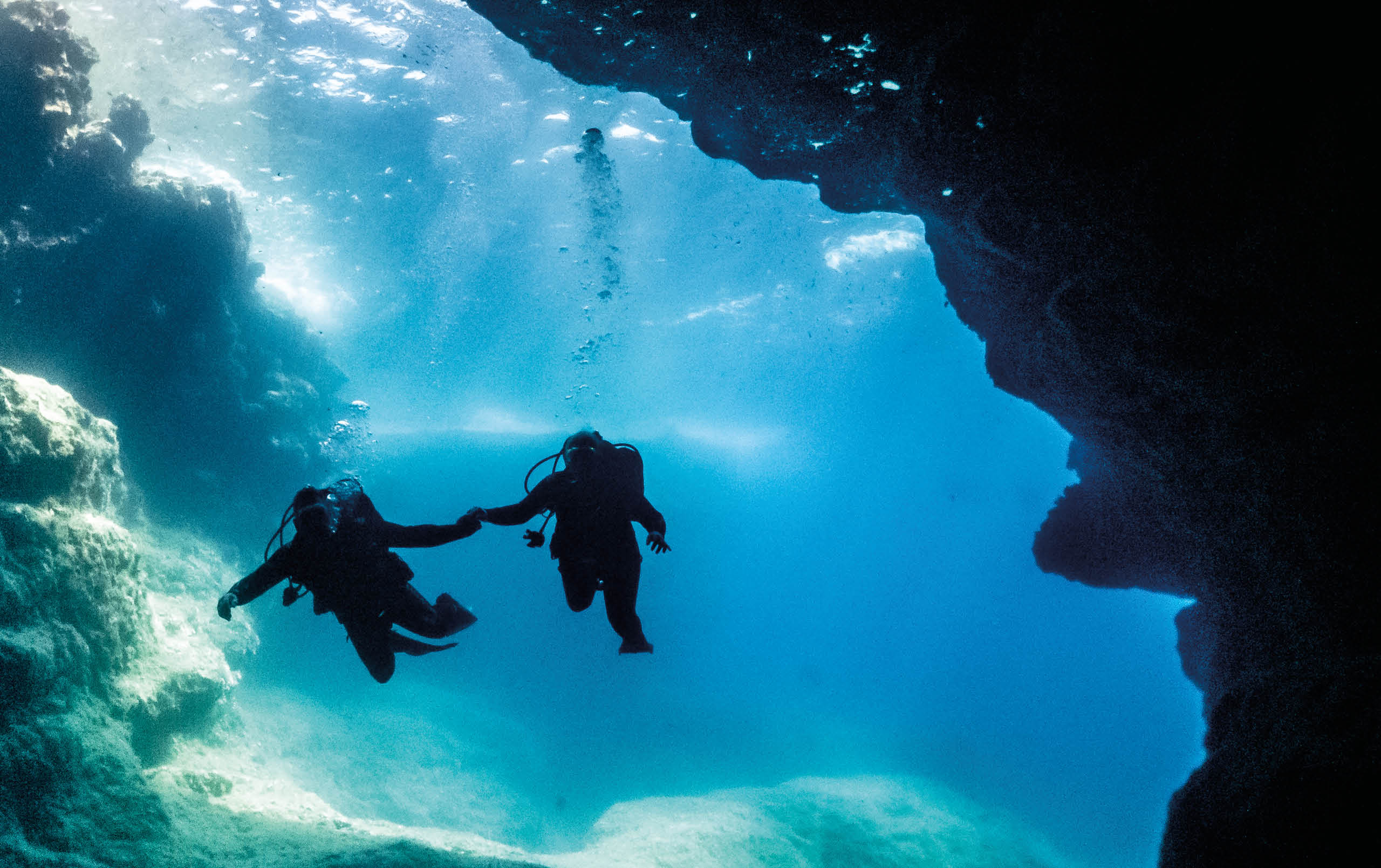 divers entering a cave system