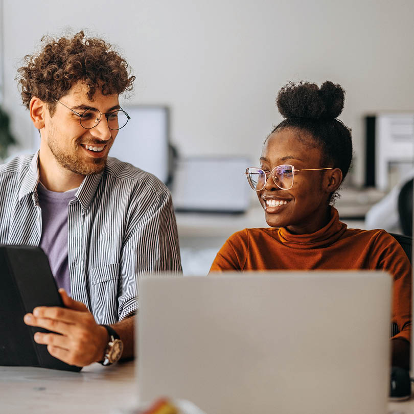 Two young colleagues working together at modern office